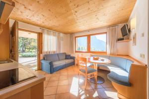 a small living room with a table and a couch at AppartmentPircher 2 in Siusi