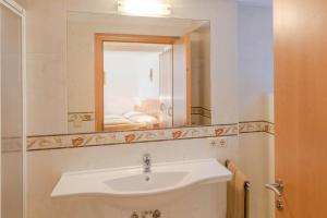 a bathroom with a sink and a mirror at AppartmentPircher 2 in Siusi +4 photos