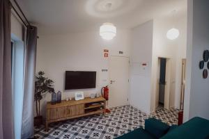 a living room with a flat screen tv on a wall at Peace In Azores 02 in Ribeira Grande