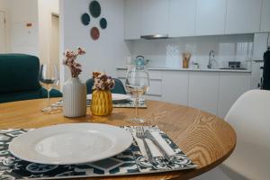 a table with a plate and wine glasses on it at Peace In Azores 02 in Ribeira Grande