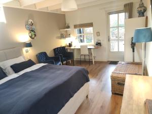 a bedroom with a bed and a table and chairs at B&B Hoofddorp in Hoofddorp