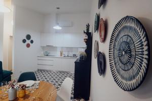 a kitchen with a table and a plate on a wall at Peace In Azores 02 in Ribeira Grande +7 photos