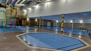 a large swimming pool in a large building at Driftwood at Freshwater Beach Holiday Park in Burton Bradstock +39 photos