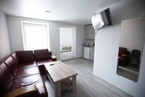 a living room with a couch and a table at Dzūkija Hotel in Alytus +49 photos