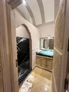 a bathroom with a sink and a large mirror at Privat Villa in Marrakesch with Pool & Garten in Marrakesh +139 photos