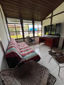 a room with a couch and a desk and a table at Villa Del Viento in Calima