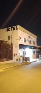 a hotel building at night with the lights on at Hotel Por Do Sol in Rio Verde