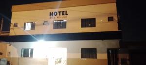 a hotel sign on the side of a building at Hotel Por Do Sol in Rio Verde