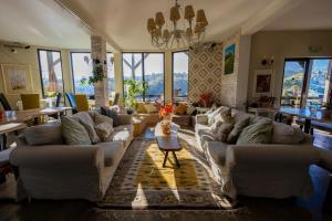 a living room with white couches and a table at Akasha Retreat in Bran