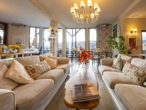 a living room with a couch and a table at Akasha Retreat in Bran