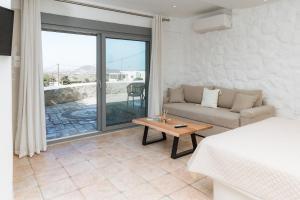 a living room with a couch and a table at The Stone House Naxos in Glinado Naxos