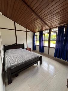 a bedroom with a bed in a room with windows at Villa Del Viento in Calima +13 photos