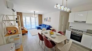 a kitchen and living room with a table and chairs at Thalassa Beach Resort - 107 in Vokolidha