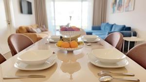 a table with a bowl of fruit on top of it at Thalassa Beach Resort - 107 in Vokolidha