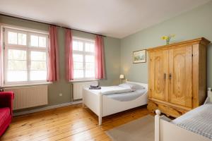 a bedroom with a bed and two windows at Brauhaus am Schloss in Gartow +16 photos