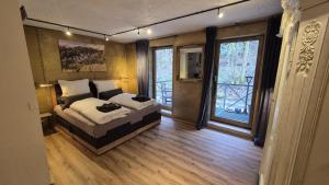 a bedroom with a bed and a large window at Refugium Altstadt in Monschau
