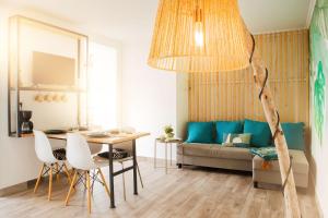 a living room with a couch and a table at Casa da Vila Apartments in Arco da Calheta +9 photos