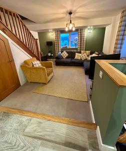 a living room with a couch and a table at Bakers Cottage in Cockermouth