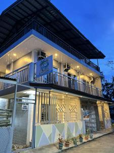 a building with a balcony on the side of it at Casa Vina El Nido in El Nido