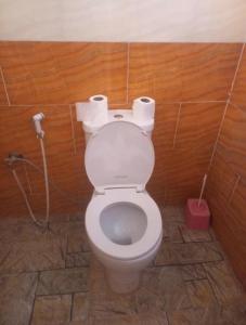a bathroom with a toilet with two rolls of toilet paper at Wadi Rum Bedouin Story Camp & Tours in Wadi Rum