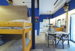 a bedroom with a bunk bed and a table and chairs at Stara Olejarnia in Nowe Miasto Lubawskie