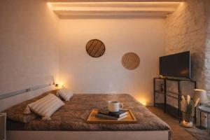 a bedroom with a bed with a tray on it at Little Urban Home in Trieste