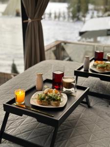 a table with two plates of food and drinks on it at Kihnuvillas - Männirahu in Linaküla