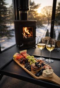 a table with a plate of food and two glasses of wine at Kihnuvillas - Männirahu in Linaküla