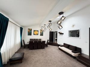a living room with a couch and a table at Casa Paltinoasa in Păltinoasa