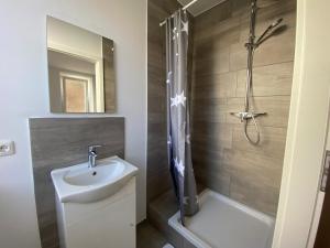 a bathroom with a sink and a shower at Pension Augsburg Ost in Augsburg