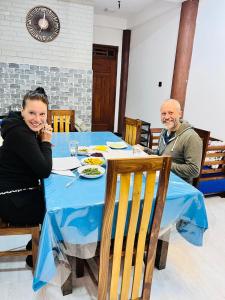 a man and a woman sitting at a table at Ohiya Alpine River Lodge in Ohiya
