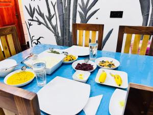 a blue table with plates of food on it at Ohiya Alpine River Lodge in Ohiya