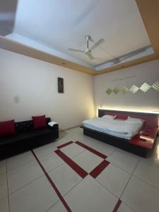 a bedroom with a bed and a ceiling at Auranest Stays Duplex Home in Ludhiana