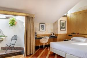 a bedroom with a bed and a table and chairs at Hotel Sanpi Milano in Milan +87 photos