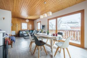 a dining room and living room with a table and chairs at Clairmatin - Plein Centre de La Bresse in La Bresse