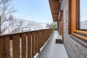 a balcony of a house with snow on the ground at Clairmatin - Plein Centre de La Bresse in La Bresse