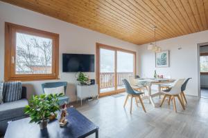 a living room with a couch and a table at Clairmatin - Plein Centre de La Bresse in La Bresse
