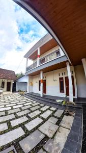 a building with a stone walkway in front of it at Arka Homestay Pesagi in Karangasem