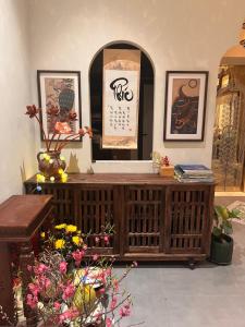 a shop with a wooden counter with flowers and pictures at Tranquility Suites Westlake in Hanoi