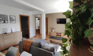 a living room with a couch and a tv at Casa rural Solpor in Vigo