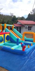 a inflatable water play set on a blue tarp at Mersing Chalet Teluk Sisek in Kampong Sisek