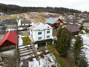 an aerial view of a village in the snow at Casa Paltinoasa in Păltinoasa