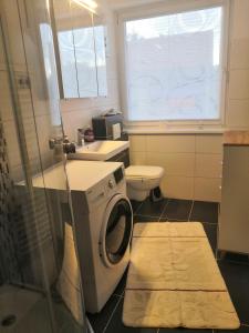 a bathroom with a washing machine and a sink at Monteurzimmer und Reisende in Salzgitter
