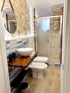 a bathroom with a sink and a toilet and a shower at Mare' in Vieste
