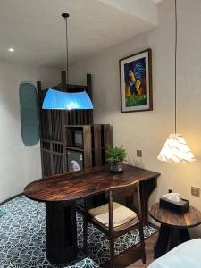 a room with a table and chairs and a lamp at Tranquility Suites Westlake in Hanoi