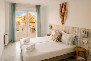 a bedroom with a large white bed and a window at Dormio Resort Costa Blanca Beach & Spa in El Campello +42 photos