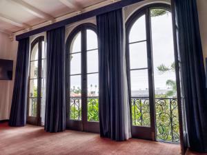 an empty room with large windows and a balcony at Maison Twenty Seven in Los Angeles