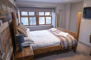 a bedroom with a bed and a window at The Milestone in Sowerby Bridge