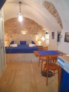 a bedroom with a blue bed and a table at Mare' in Vieste