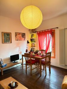 a dining room with a table and chairs and a chandelier at Bed & Breakfast Villa Buzzati in Belluno
